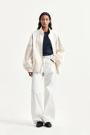 BACK LOGO HIGH NECK JUMPER IN CREAM image 10
